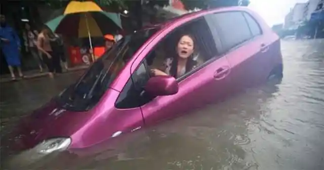 Stranded in Style: A Purple Car’s Waterlogged Woes